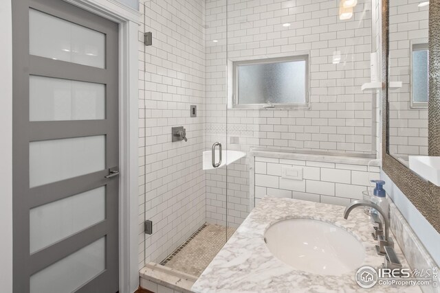 full bath with a sink and a shower stall