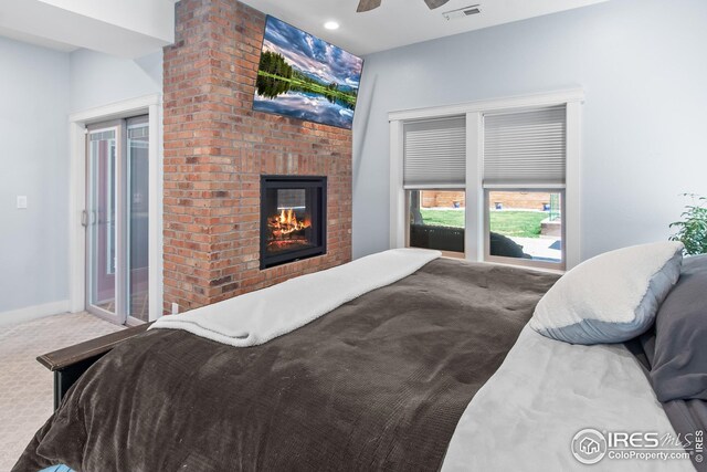 bedroom featuring a fireplace, carpet floors, a ceiling fan, baseboards, and visible vents