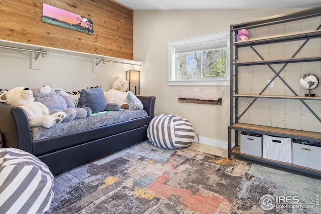 bedroom featuring baseboards and lofted ceiling