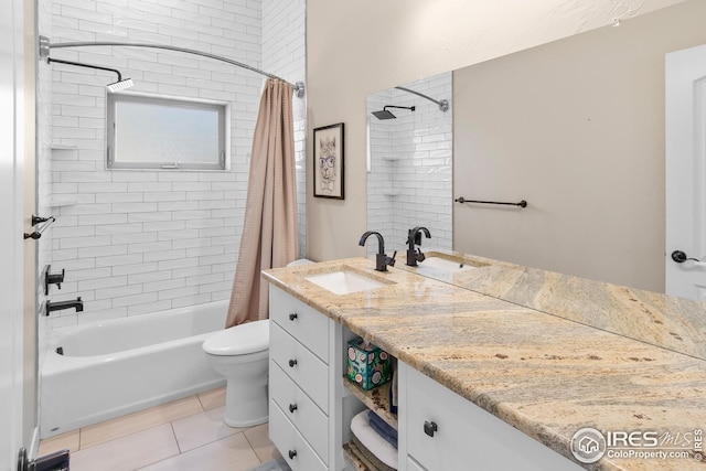 full bathroom with vanity, shower / tub combo with curtain, tile patterned floors, and toilet