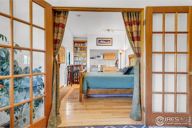 bedroom with wood-type flooring