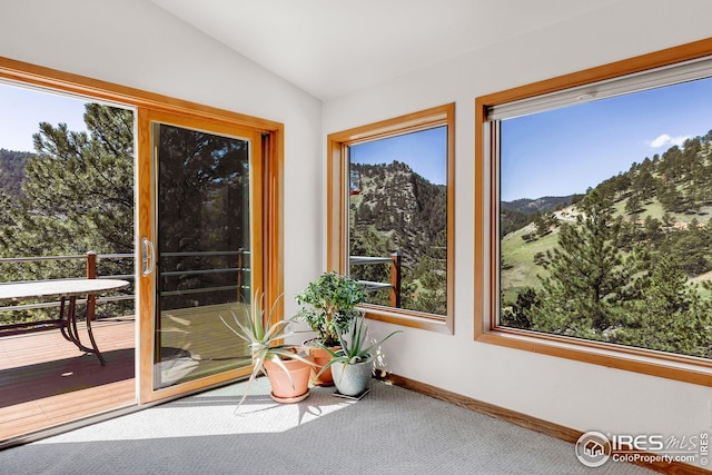 sunroom / solarium featuring a mountain view