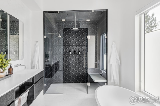 full bath with vanity, a freestanding bath, and a stall shower