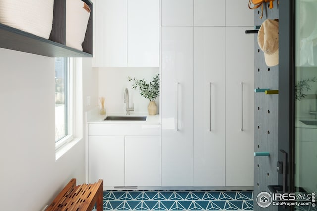 mudroom featuring plenty of natural light and a sink