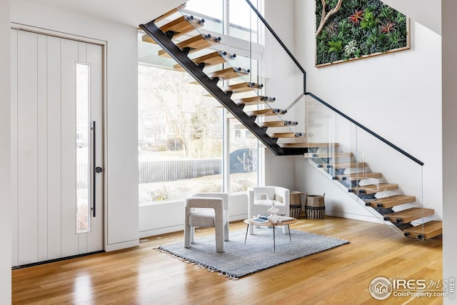 foyer entrance featuring stairs and wood finished floors