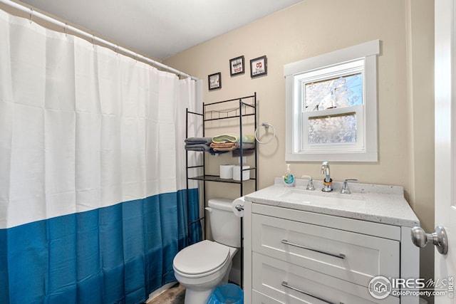 bathroom with vanity, a shower with curtain, and toilet