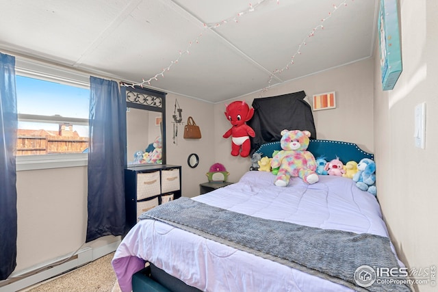 bedroom with a baseboard heating unit and speckled floor