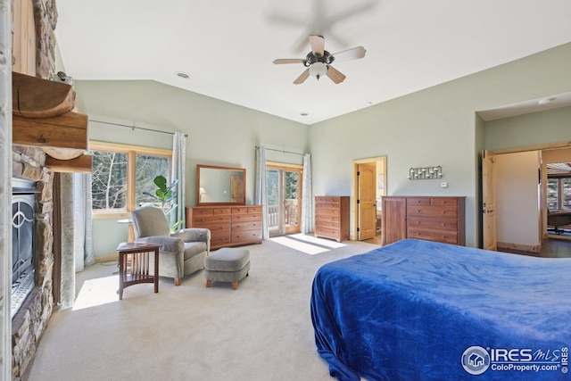 carpeted bedroom featuring access to outside, ceiling fan, a fireplace, vaulted ceiling, and visible vents