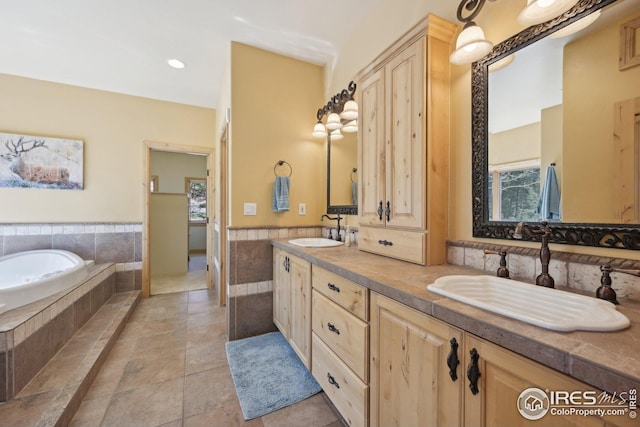bathroom featuring a sink, double vanity, wainscoting, and a bath