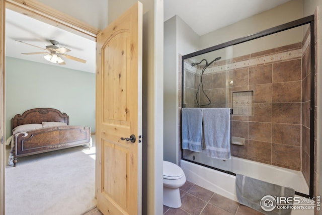 bathroom with toilet, shower / bath combination with glass door, ceiling fan, connected bathroom, and tile patterned floors