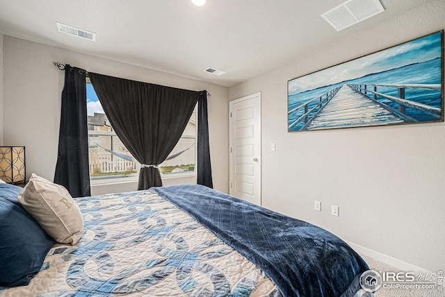 bedroom with baseboards, carpet flooring, and visible vents