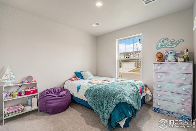 carpeted bedroom featuring visible vents