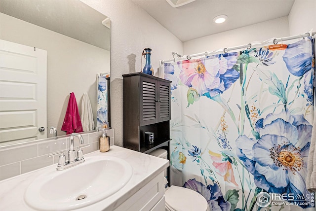 bathroom with a shower with curtain, backsplash, vanity, and toilet