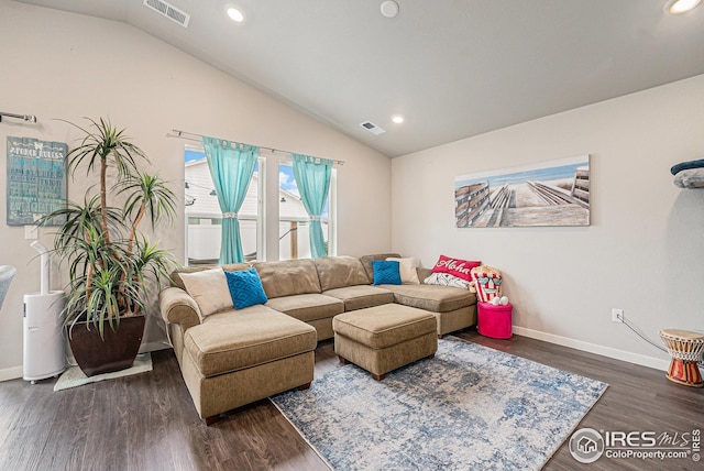 living area with visible vents, baseboards, and lofted ceiling