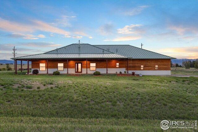 rear view of house with metal roof and a standing seam roof