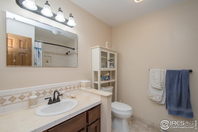 full bath with a shower with curtain, tasteful backsplash, tile patterned flooring, vanity, and toilet