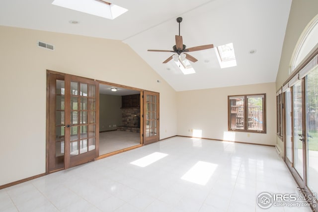 unfurnished room with a skylight, visible vents, and french doors