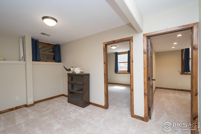 interior space featuring baseboards, visible vents, and carpet