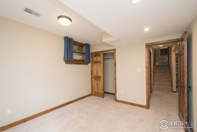 unfurnished bedroom with light colored carpet, recessed lighting, baseboards, visible vents, and a closet
