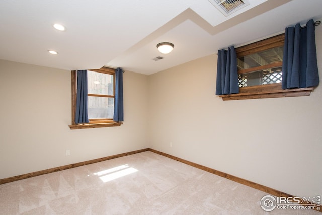 carpeted spare room with recessed lighting, baseboards, and visible vents