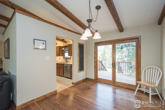 dining room featuring baseboards, lofted ceiling with beams, and light wood-style flooring