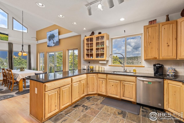 kitchen with stainless steel dishwasher, a peninsula, recessed lighting, and glass insert cabinets