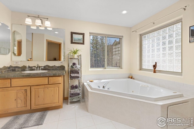 bathroom featuring a whirlpool tub, recessed lighting, tile patterned floors, and vanity