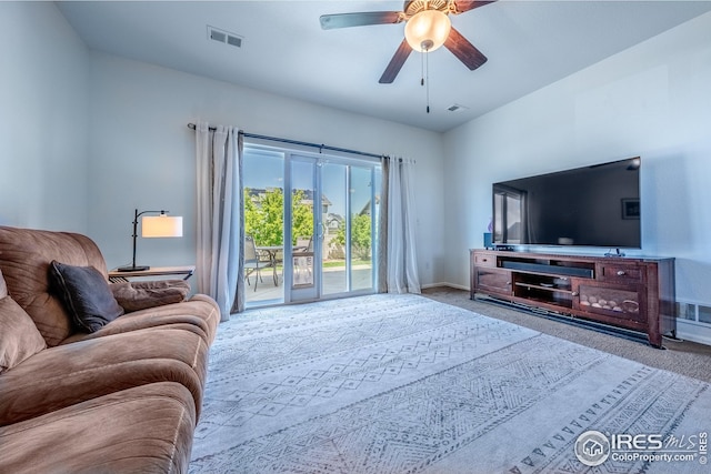 carpeted living room featuring a ceiling fan, baseboards, and visible vents