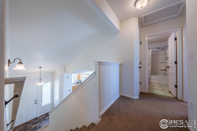 hallway featuring carpet and an upstairs landing
