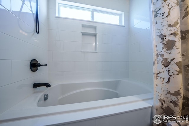 bathroom with shower / bathtub combination with curtain