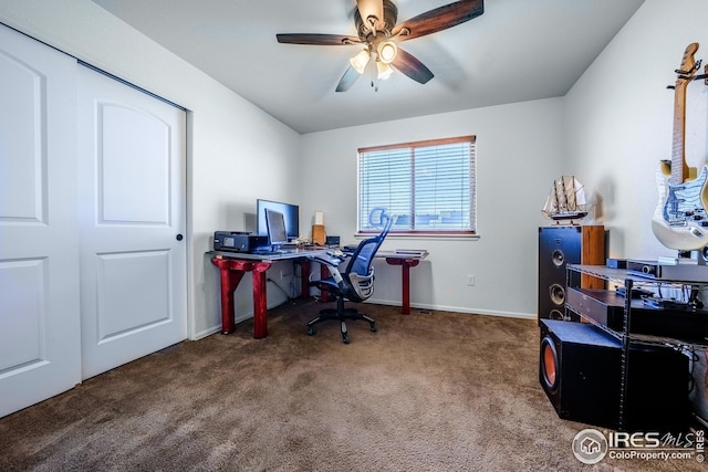 office area featuring carpet floors, ceiling fan, and baseboards
