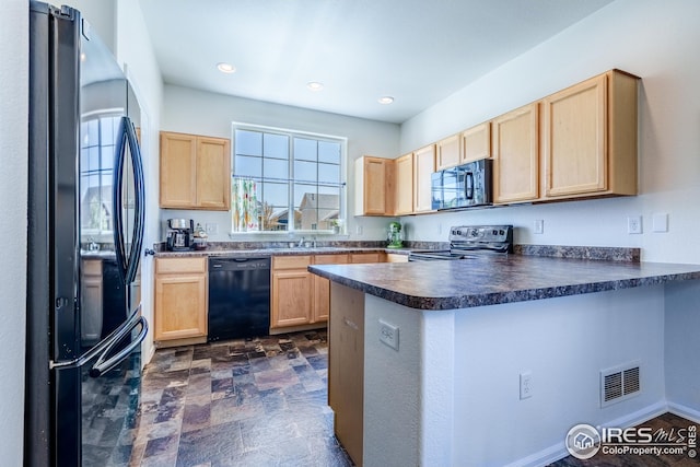 kitchen featuring a peninsula, dark countertops, black appliances, and light brown cabinets