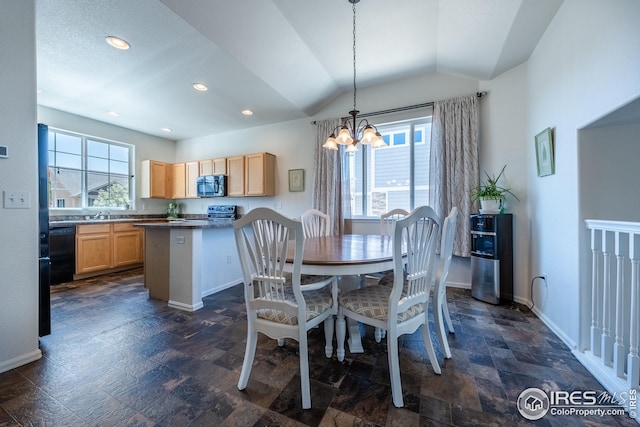 dining space featuring vaulted ceiling, a chandelier, a wealth of natural light, and stone finish floor