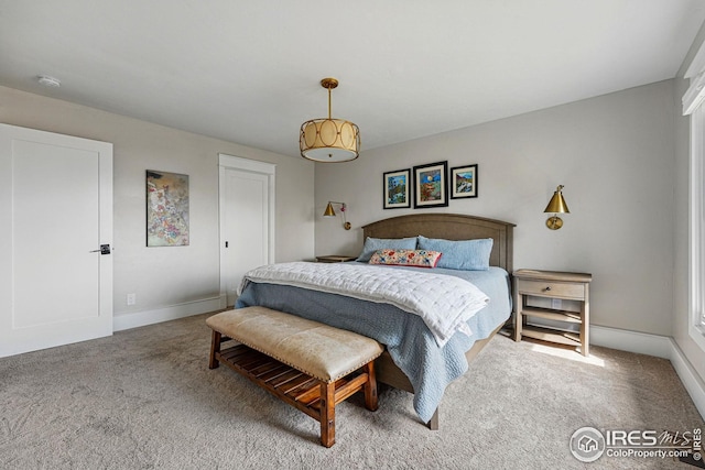 carpeted bedroom featuring baseboards
