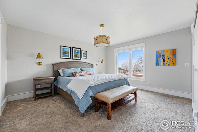carpeted bedroom featuring baseboards