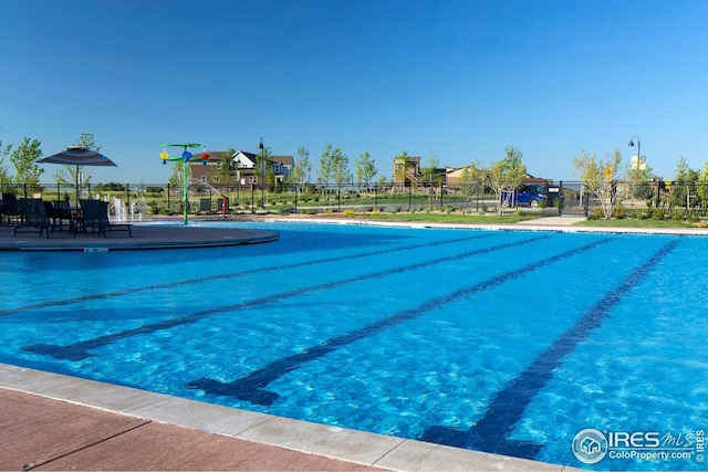 community pool featuring fence