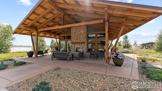 view of patio with a water view and outdoor lounge area