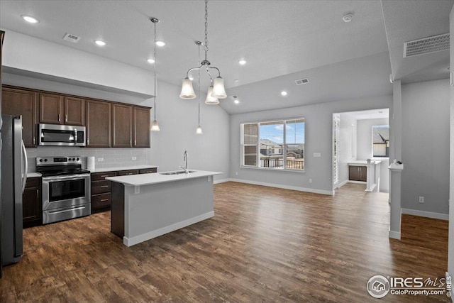 kitchen featuring visible vents, appliances with stainless steel finishes, a sink, light countertops, and a chandelier