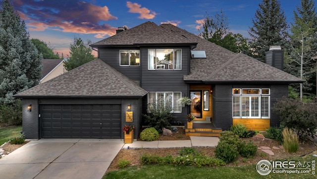 view of front of home featuring a shingled roof and a chimney