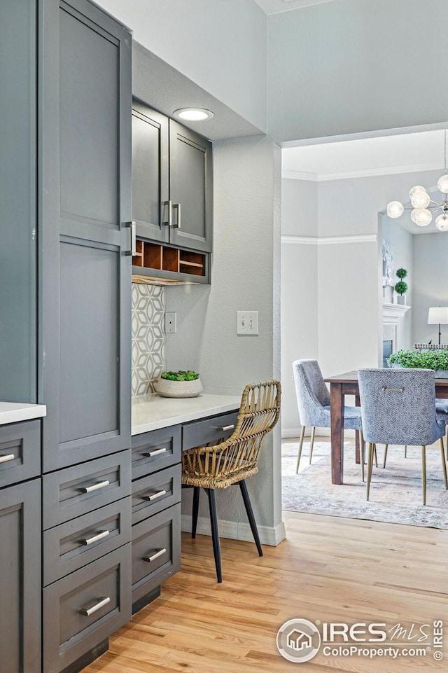 interior space featuring baseboards, light wood-style flooring, and a chandelier