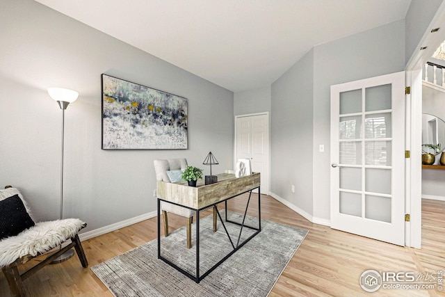 home office featuring baseboards and wood finished floors