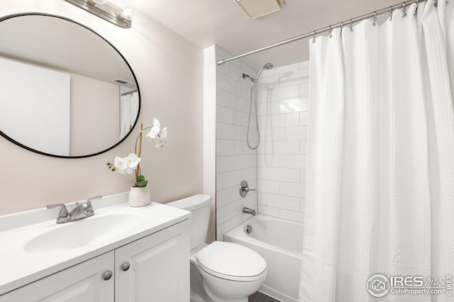bathroom featuring vanity, shower / bath combo with shower curtain, and toilet