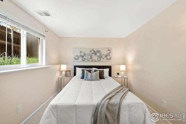 bedroom featuring baseboards, visible vents, and carpet