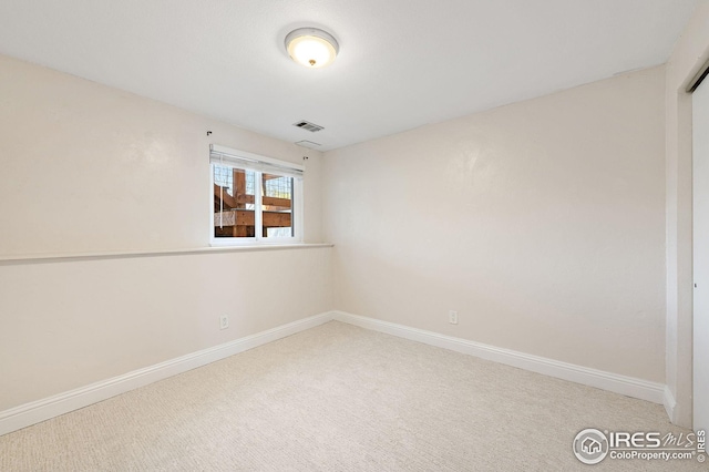carpeted empty room with baseboards and visible vents