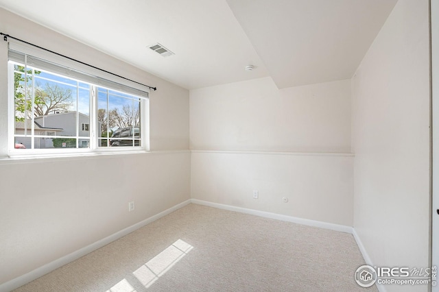 carpeted empty room with baseboards and visible vents