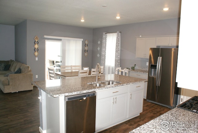 245 Swallow Rd, Johnstown, CO 80534 - kitchen featuring appliances with stainless steel finishes, a sink, dark wood-style floors, a center island with sink, and white cabinets