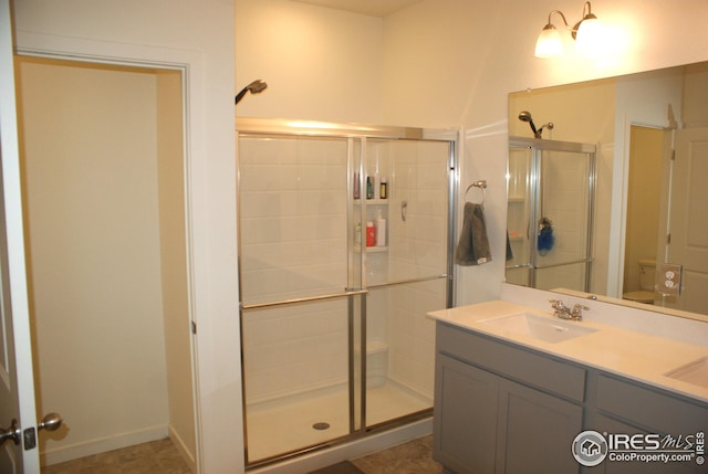 245 Swallow Rd, Johnstown, CO 80534 - bathroom featuring a stall shower, toilet, and double vanity
