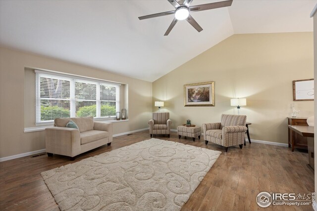 living room featuring a ceiling fan, wood finished floors, and vaulted ceiling