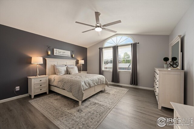 bedroom featuring baseboards, ceiling fan, vaulted ceiling, and dark wood-style flooring