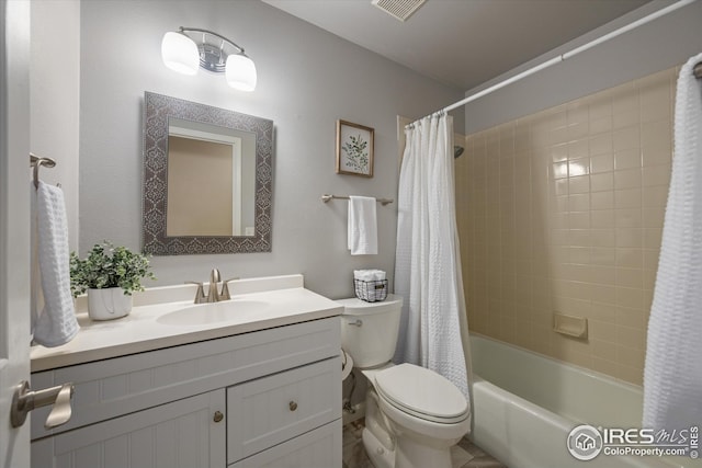 bathroom with vanity, shower / tub combo, toilet, and visible vents